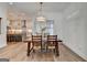Dining room features an elegant chandelier, wood table and view into the modern kitchen at 1006 Fendley St, Woodstock, GA 30188