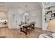 Bright dining room featuring wood floors, modern chandelier, and white walls at 1006 Fendley St, Woodstock, GA 30188