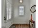 Bright and airy foyer with hardwood floors, white door with window shutters, and decorative accessories at 1006 Fendley St, Woodstock, GA 30188