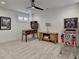 Spacious game room featuring pinball machines, carpet and a ceiling fan at 1006 Fendley St, Woodstock, GA 30188