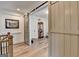 Hallway with decorative sliding barn doors leading to a beautifully decorated room with hardwood floors at 1006 Fendley St, Woodstock, GA 30188