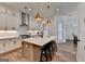 Modern kitchen with a kitchen island, quartz countertops, and stainless steel appliances at 1006 Fendley St, Woodstock, GA 30188