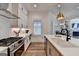 Modern kitchen featuring quartz countertops, stainless steel appliances, and plenty of storage at 1006 Fendley St, Woodstock, GA 30188