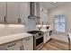 Gourmet kitchen with quartz countertops, subway tile backsplash, and stainless steel appliances at 1006 Fendley St, Woodstock, GA 30188