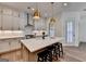 Modern kitchen with a kitchen island, quartz countertops, and stainless steel appliances at 1006 Fendley St, Woodstock, GA 30188