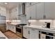 Stylish kitchen with stainless steel appliances, light countertops and cabinetry and wooden floors at 1006 Fendley St, Woodstock, GA 30188