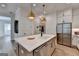 Well-lit kitchen featuring a large island with a white countertop and modern stainless steel appliances at 1006 Fendley St, Woodstock, GA 30188