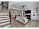 Spacious living room featuring hardwood floors, modern fireplace, built-in shelving, and adjacent dining area at 1006 Fendley St, Woodstock, GA 30188
