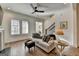 Living area with ample natural light, hardwood floors, a decorative lamp, and stylish furnishings at 1006 Fendley St, Woodstock, GA 30188