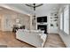 Bright living room with hardwood floors, modern fireplace, built-in shelving, and open layout dining area at 1006 Fendley St, Woodstock, GA 30188