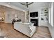 Bright living room with hardwood floors, modern fireplace, built-in shelving, and open layout dining area at 1006 Fendley St, Woodstock, GA 30188