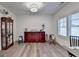 Bright room with hardwood floors, decorated with cabinet, chairs, and shuttered windows at 1006 Fendley St, Woodstock, GA 30188