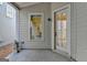 Covered patio featuring a garden statuette, window, and door at 1006 Fendley St, Woodstock, GA 30188
