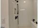Modern shower with white subway tile, matte black fixtures and convenient built-in bench at 1006 Fendley St, Woodstock, GA 30188