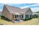 A covered patio with an outdoor dining area set in the private backyard at 100 Maple Leaf Rd, Sharpsburg, GA 30277