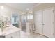 Bright bathroom with walk-in shower, tile flooring and a view into the bedroom at 100 Maple Leaf Rd, Sharpsburg, GA 30277
