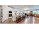 Kitchen with white cabinets and stainless steel appliances, plus island seating, open to the dining area at 100 Maple Leaf Rd, Sharpsburg, GA 30277