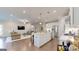 An open kitchen with white cabinets, stainless steel appliances, and a center island with barstool seating at 100 Maple Leaf Rd, Sharpsburg, GA 30277