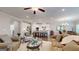 Open concept living room with white walls, hardwood floors, and an island that leads to the kitchen at 100 Maple Leaf Rd, Sharpsburg, GA 30277
