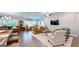 A view of an open living room with multiple seating areas and hardwood floors at 100 Maple Leaf Rd, Sharpsburg, GA 30277