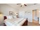 A comfortable bedroom with neutral colors, a ceiling fan, and a large bed at 100 Maple Leaf Rd, Sharpsburg, GA 30277