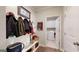 The mudroom has a bench with hooks and leads to the laundry room at 100 Maple Leaf Rd, Sharpsburg, GA 30277