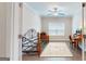 A well lit office with a ceiling fan, large window, and a daybed with a wooden frame at 100 Maple Leaf Rd, Sharpsburg, GA 30277