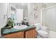 Bathroom with a green countertop, wood cabinets, a sink, a toilet, and a shower at 1211 Fly Rod Ln, Loganville, GA 30052