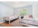 Cozy bedroom with two beds, a central window for natural light, and a ceiling fan at 1211 Fly Rod Ln, Loganville, GA 30052