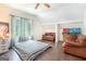 Bedroom with wood floors, ceiling fan, large windows, and comfortable leather seating at 1211 Fly Rod Ln, Loganville, GA 30052