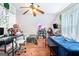 Bedroom with two beds, wood floors, ceiling fan, and a desk area at 1211 Fly Rod Ln, Loganville, GA 30052