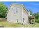 Light yellow siding home with a small porch and lawn at 1211 Fly Rod Ln, Loganville, GA 30052