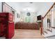 Spacious living room with a red refrigerator, sofa, and a view of the backyard at 1211 Fly Rod Ln, Loganville, GA 30052