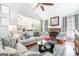 Bright living room with a stone fireplace, vaulted ceilings, and open access to the dining area at 1211 Fly Rod Ln, Loganville, GA 30052