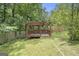 Wood pergola with seating area in a fenced yard at 1211 Fly Rod Ln, Loganville, GA 30052