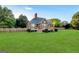 Expansive backyard featuring a well-maintained lawn, wooden fence, and a charming brick house, ideal for outdoor enjoyment at 161 Pleasant Grove Rd, Mcdonough, GA 30252