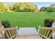 Backyard featuring new stairs to a well maintained lawn and trimmed bushes, showcasing the home's outdoor space at 161 Pleasant Grove Rd, Mcdonough, GA 30252