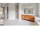 Bright bathroom features tile flooring, a walk-in shower, and a spacious vanity area with a large mirror at 161 Pleasant Grove Rd, Mcdonough, GA 30252