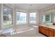 Bathroom features a large tub, wood cabinets and a large mirror with a vanity light above at 161 Pleasant Grove Rd, Mcdonough, GA 30252