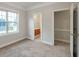 The bedroom has carpet flooring, neutral walls, and adjoins a bathroom and closet at 161 Pleasant Grove Rd, Mcdonough, GA 30252
