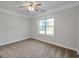 This bedroom features neutral walls, carpet flooring, and a large window at 161 Pleasant Grove Rd, Mcdonough, GA 30252