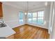 Bright dining area with hardwood floors, large windows, and a modern chandelier at 161 Pleasant Grove Rd, Mcdonough, GA 30252