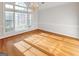 Bright, spacious dining room with hardwood floors, large windows, and elegant chandelier at 161 Pleasant Grove Rd, Mcdonough, GA 30252