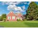 Charming brick home with well-manicured lawn and mature trees on a sunny day at 161 Pleasant Grove Rd, Mcdonough, GA 30252