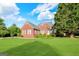 Charming brick home featuring a well-maintained lawn and inviting curb appeal under a sunny sky at 161 Pleasant Grove Rd, Mcdonough, GA 30252