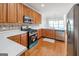 Well-lit kitchen features stainless steel appliances, wooden cabinets, and light countertops with a tiled backsplash at 161 Pleasant Grove Rd, Mcdonough, GA 30252