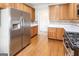 Modern kitchen boasts stainless steel refrigerator, wooden cabinets, white countertops, and stainless steel stove at 161 Pleasant Grove Rd, Mcdonough, GA 30252