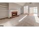 Spacious living room featuring plush carpeting, fireplace, and access to the foyer at 161 Pleasant Grove Rd, Mcdonough, GA 30252