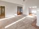 Bright living room with neutral carpet, leading to a hallway, the kitchen, and a sunroom with outside access at 161 Pleasant Grove Rd, Mcdonough, GA 30252