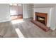 Cozy living room featuring plush carpeting and brick fireplace, filled with natural light at 161 Pleasant Grove Rd, Mcdonough, GA 30252